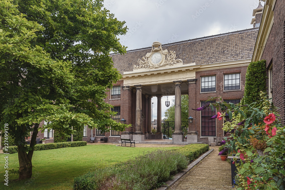 The entrance of the almshouse the green garden in the old center of Haarlem