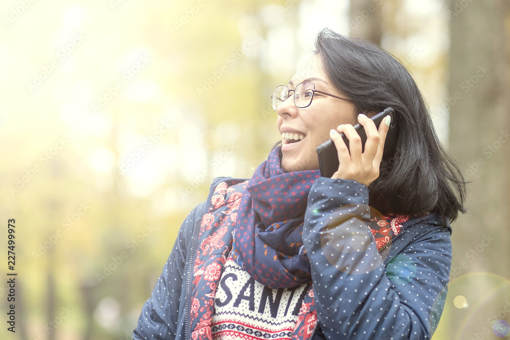 Closeup portrait of a beautiful confident woman laughing in nature. Telephone conversation with your loved one. Good news. Closeup portrait of a beautiful confident woman laughing in nature. Telephone conversation with your loved one. Good news.