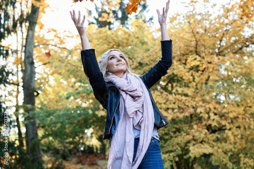 young woman enjoying autumn outdoors