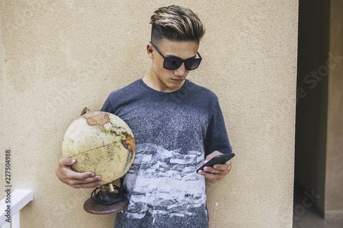 young handsome teenager millennial people dreaming travel lifestyle discovering the entire world living a different life from the usual people with the help of internet technology photo