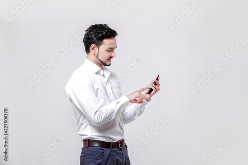 Young indian man using mobile 