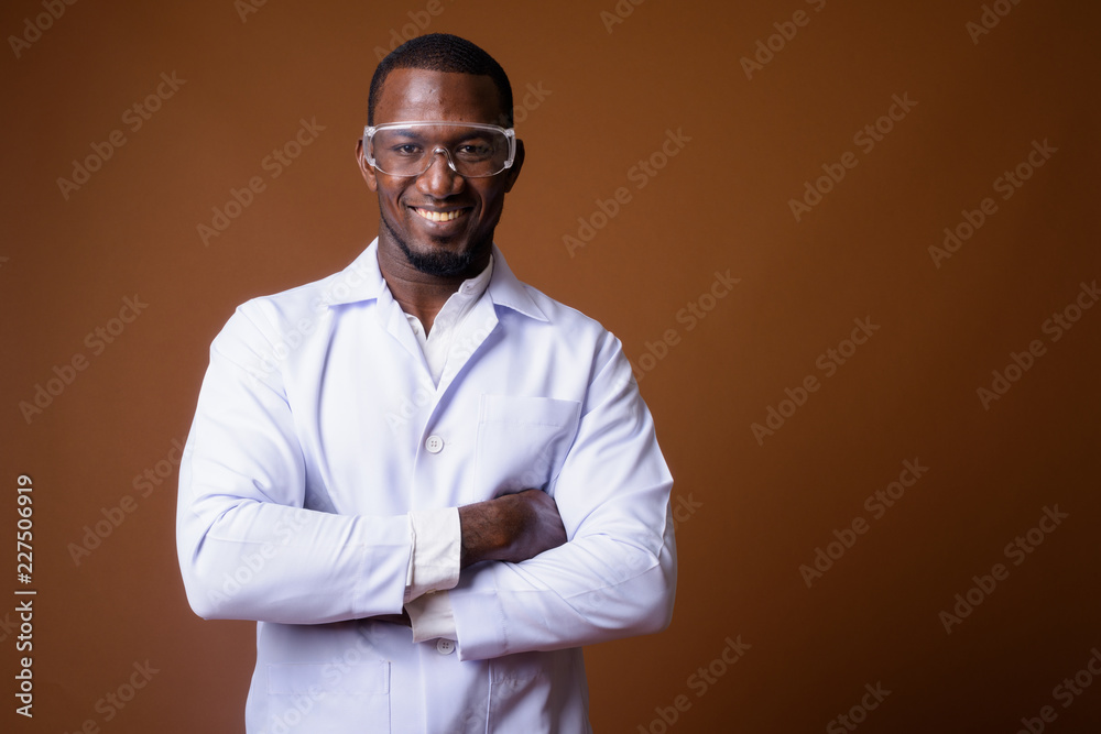 Handsome African man doctor wearing protective glasses Handsome African man doctor wearing protective glasses