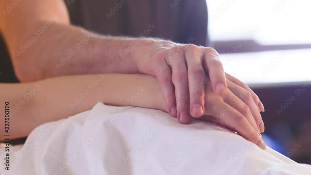 Man's hand stroking a woman's hand, close-up Man's hand stroking a woman's hand, close-up