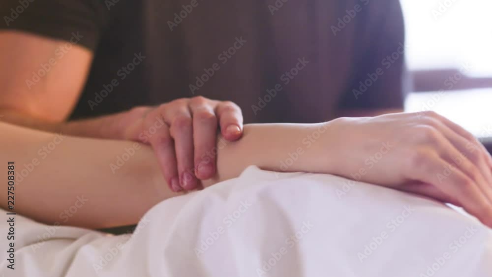 Man's hand stroking a woman's hand, close-up Man's hand stroking a woman's hand, close-up