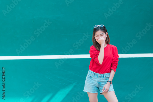 Portrait of beautiful asian woman wear skirt at tennis course,Pose for take a picture,Thailand people,Lifestyle of modern girl