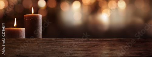 Candles with wooden table and bokeh background