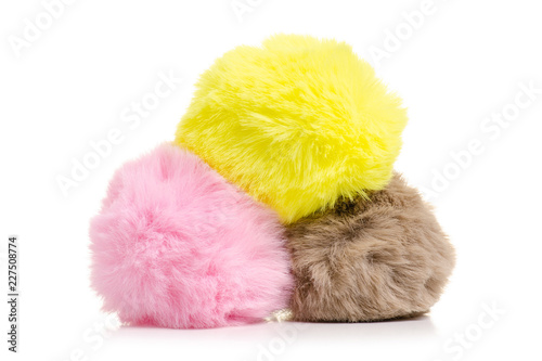 Fur balls yellow pink brown on white background isolation