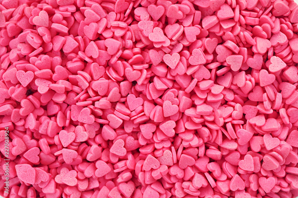 Pink heart sweet sugar confetti festive background, love concept image, valentine's day texture card, selective focus