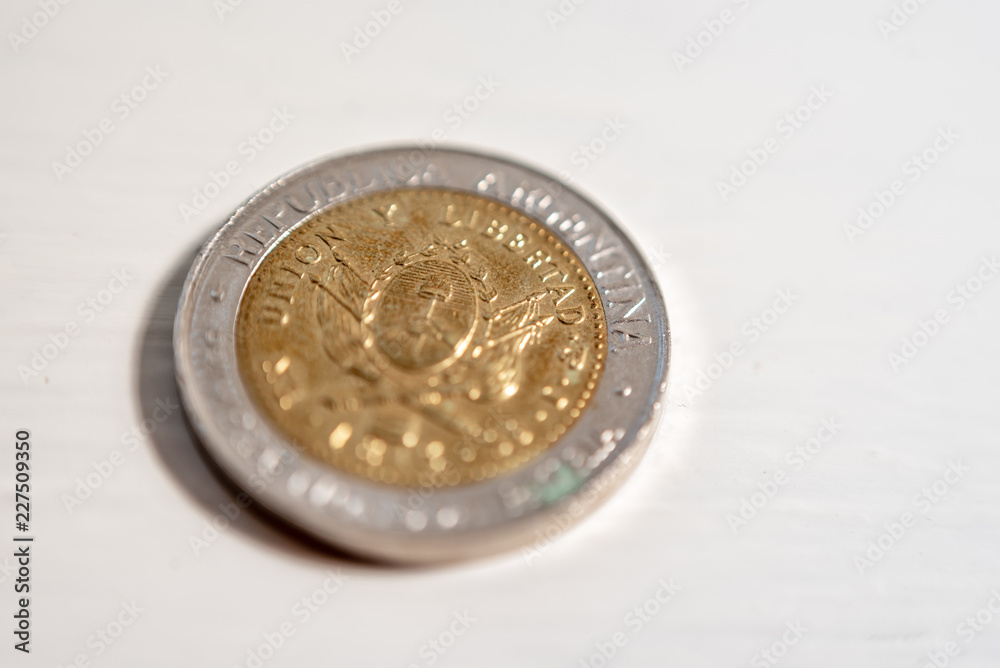 Macrophotography of one Argentine peso coin on a white background Macrophotography of one Argentine peso coin on a white background