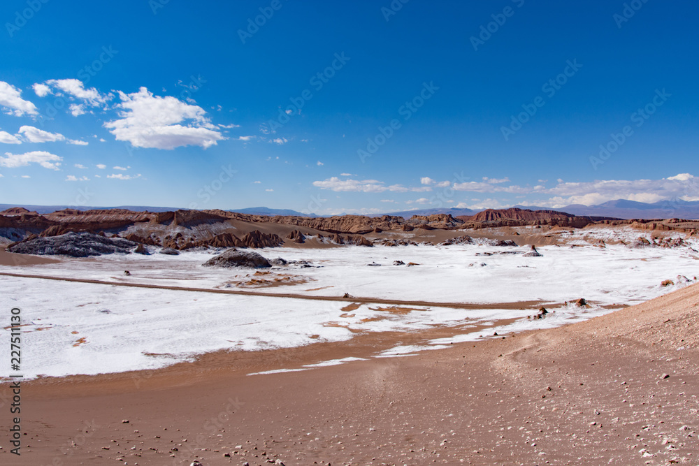 Sand dunes with salt deposits in the Atacama Desert, Chile on a sunny day with blue sky