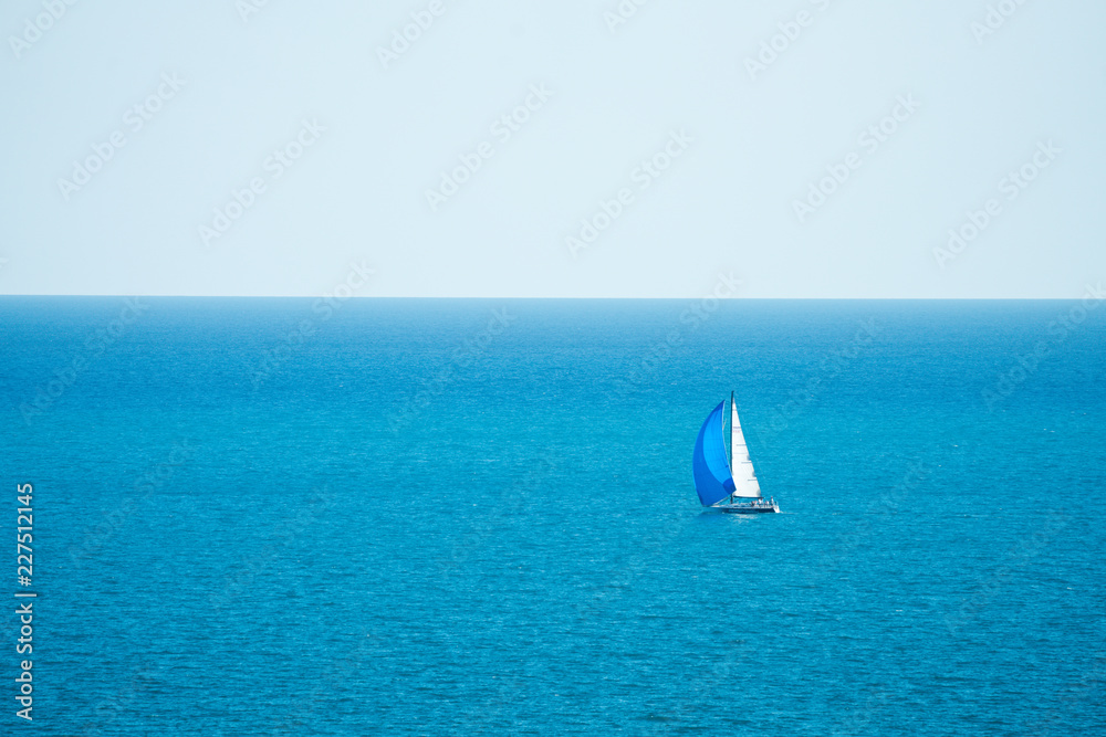small sailboat floating in the sea
