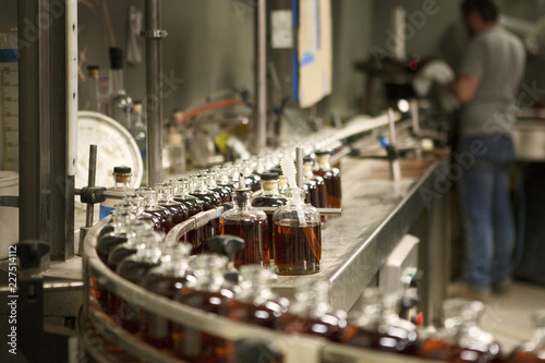 Whiskey bottles in row at distillery