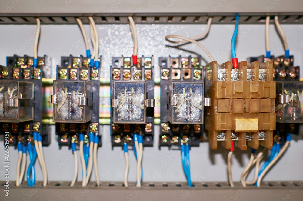 Several old relays with connected colored wires.