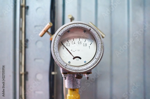 Pressure gauge showing zero mounted on a yellow colored gas pipeline.