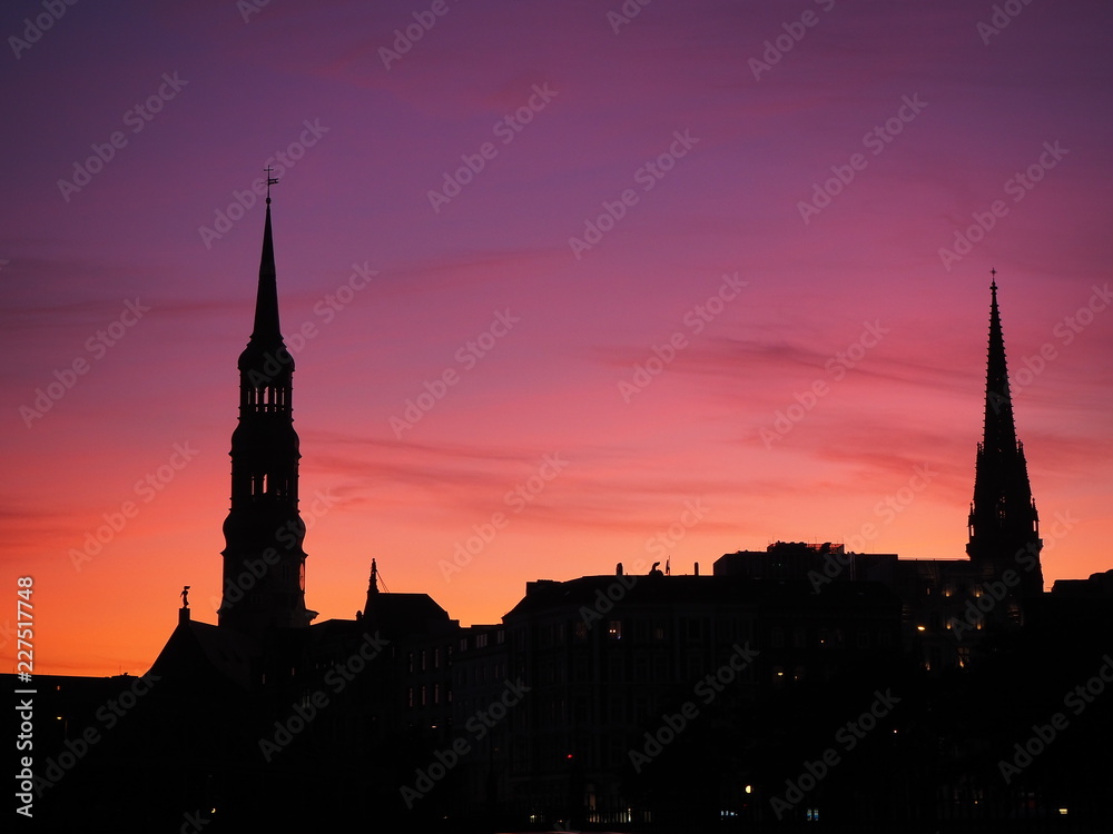 Hamburg silhouette of the city and bell towers with pink and red sunset
