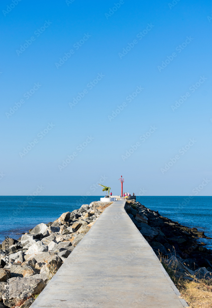Empty boardwalk along blue beach on bright sunny day Empty boardwalk along blue beach on bright sunny day