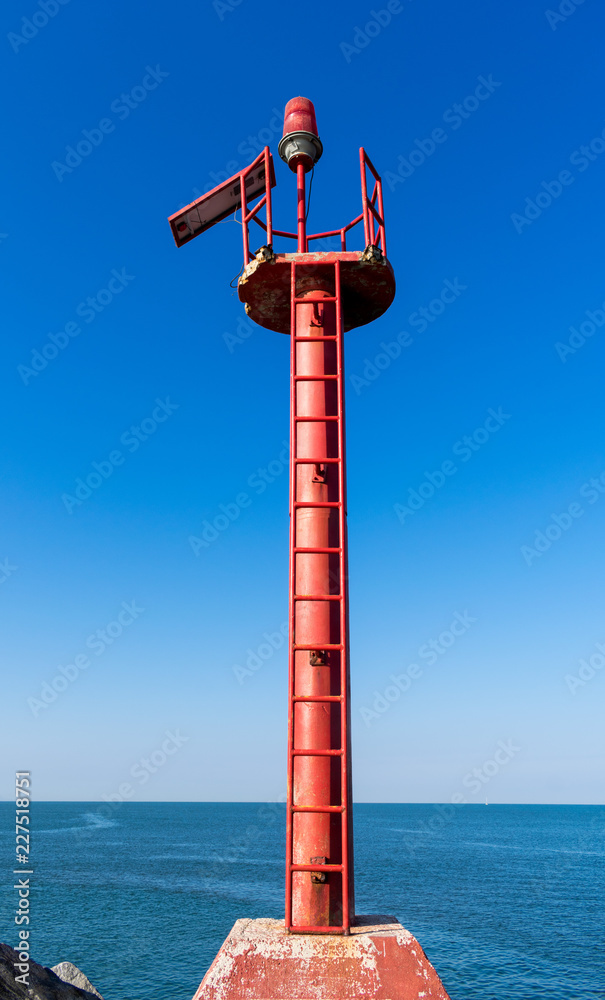 Red lighthouse tower pole with blue beach horizon in Puerto Vallarta Nayarit Red lighthouse tower pole with blue beach horizon in Puerto Vallarta Nayarit