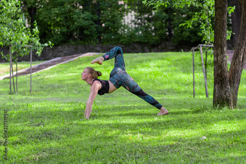 Yoga. Young Woman doing Yoga Exercises Outdoor