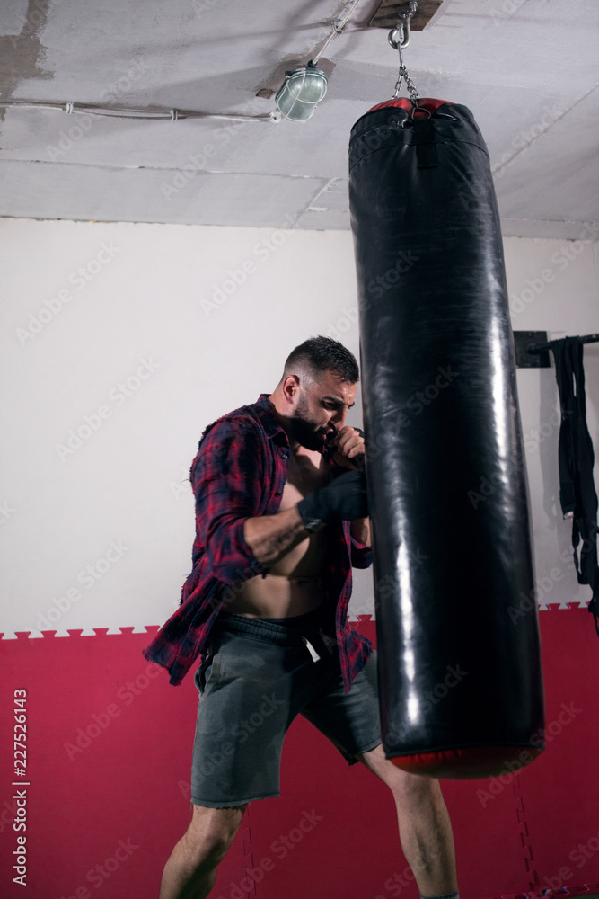 Man punching a bag on a boxing training