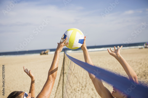 Photos Friends playing beach volleyball on sunny day
