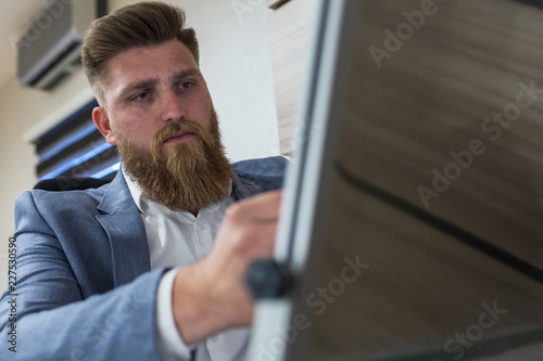 Businessman siting in office late night work writting on board