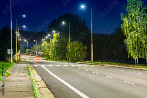 Fototapeta Naklejka Na Ścianę i Meble -  night empty road with modern LED street lights, entrance to a small town