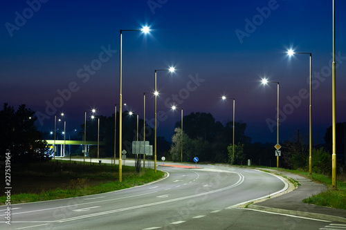 Fototapeta Naklejka Na Ścianę i Meble -  night empty road with modern LED street lights, entrance to a small town
