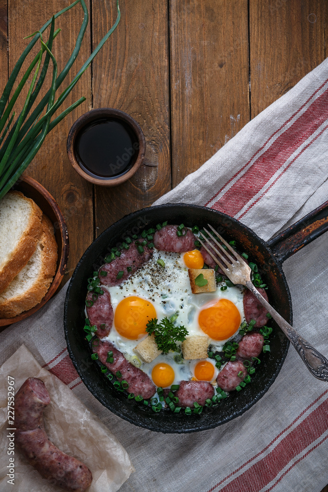 Frying pan with tasty cooked egg and sausages on table, copy space Frying pan with tasty cooked egg and sausages on table, copy space