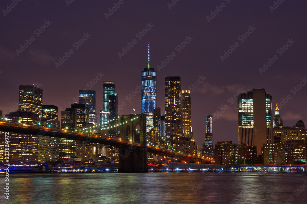 New York Manhattan skyline and Brooklyn Bridge by night