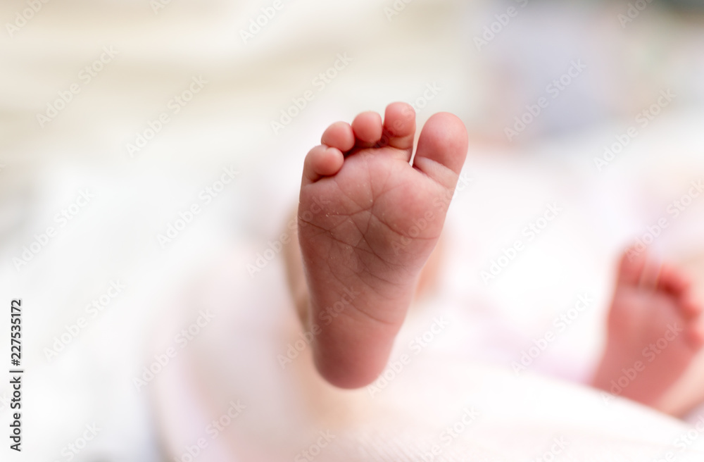foot and fingers of a newborn baby, with white background out of focus. foot and fingers of a newborn baby, with white background out of focus.