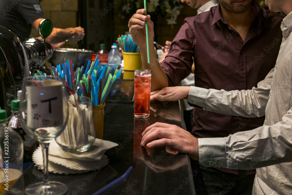 custom made wallpaper toronto digitalTwo man  are standing at a bar counter and holding  glass with an alcoholic cocktail  Red cocktail in a glass at a nightclub, beach, restaurant