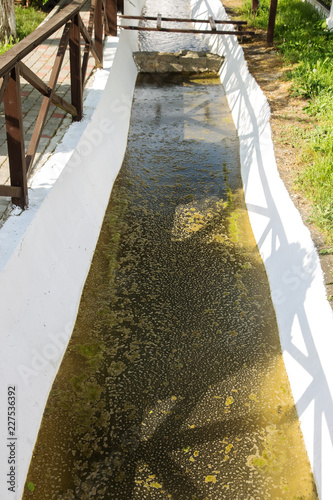 Contaminated water, sewage waste is drained through pipe into sea on an unequipped beach. Pollution of environment, ecological catastrophe. Environmental problem of environmental pollution photo