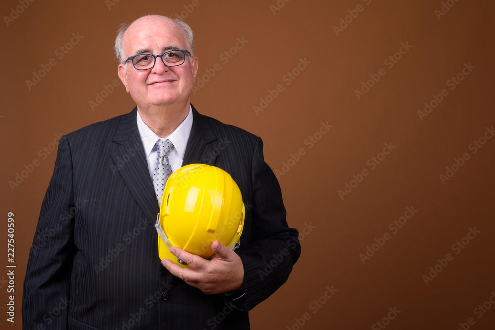 Portrait of overweight senior businessman with hardhat Portrait of overweight senior businessman with hardhat