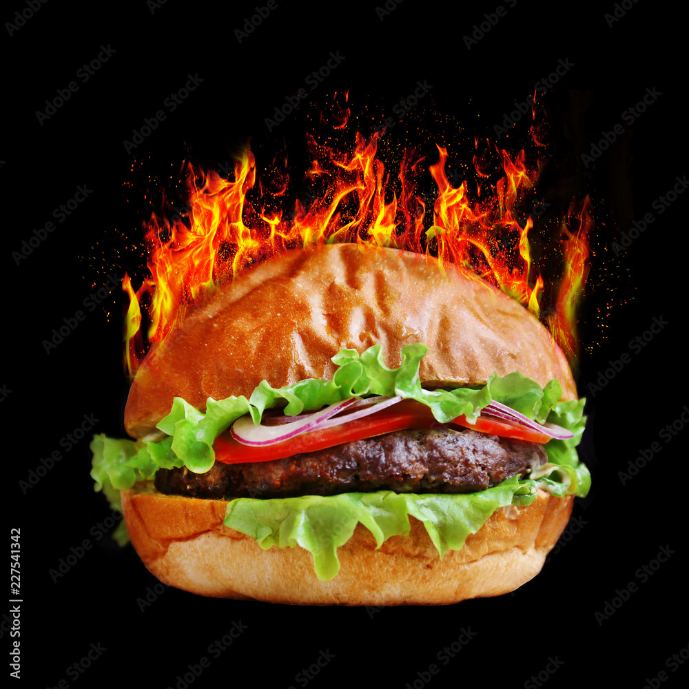 burger in fire. burger isolated on black bacground. tasty big burger