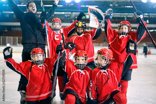 portrait of happy boys players team ice hockey .