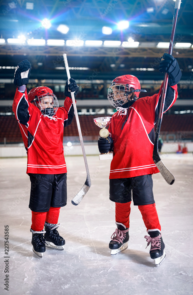 Naklejka premium happy boys players ice hockey winner trophy.