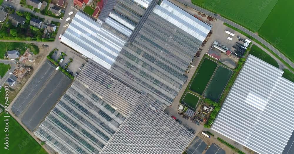 European city near greenhouses, a large greenhouse complex near the European village, Google Maps illusion