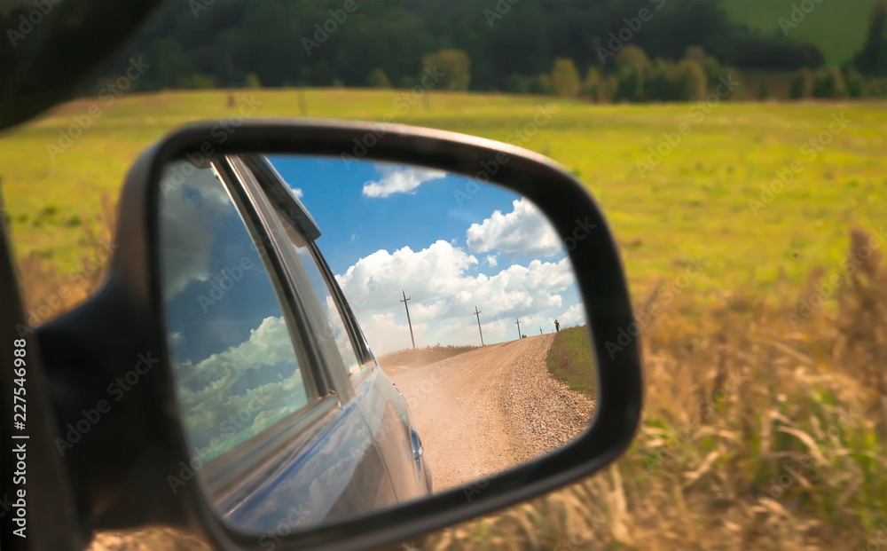 adventure and travel view reflection in the car side mirror of the world and the road