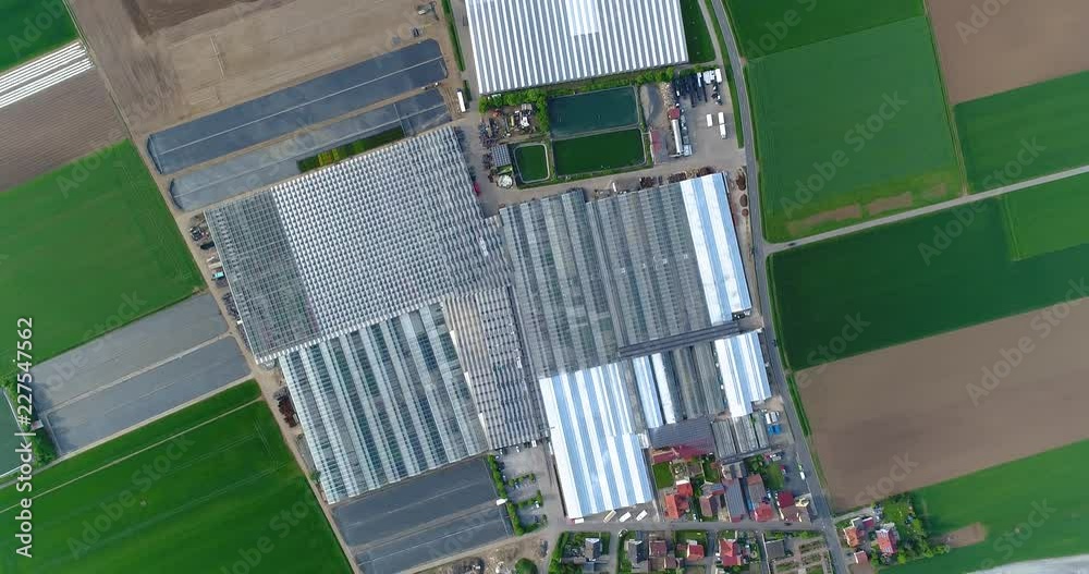 European city near greenhouses, a large greenhouse complex near the European village, Google Maps illusion
