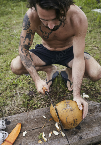 Man opening coconut