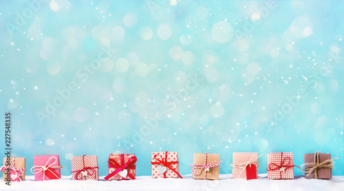 Wallpaper Mural Collection of Christmas gift boxes in a snow covered landscape Torontodigital.ca