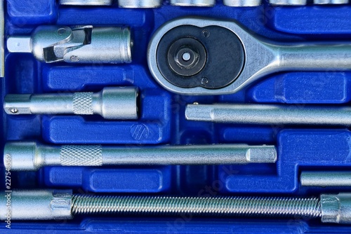 set of gray iron keys in a blue plastic box