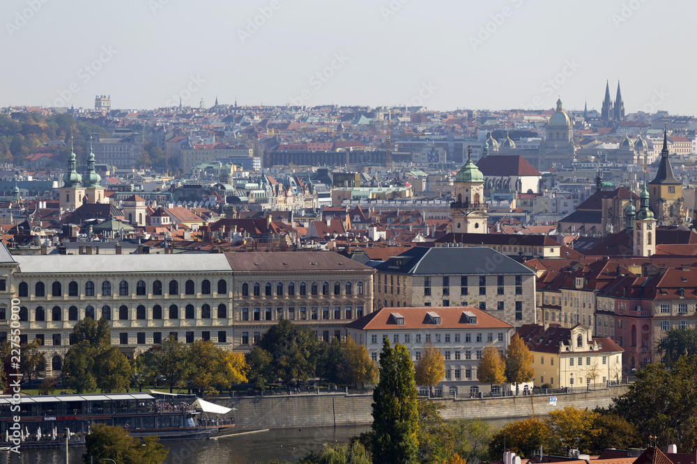 Obraz premium Autumn Prague City with with its Buildings, Towers, Cathedrals and Bridges in the sunny Day, Czech Republic