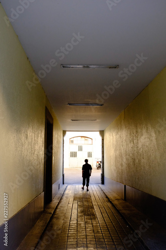 Solitary figure in a passageway