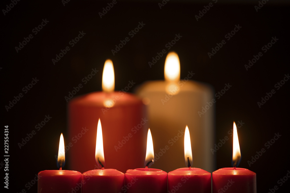 Christmas candles illuminate on dark background Christmas candles illuminate on dark background