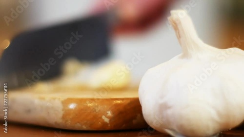 Chef minces garlic, close up photo