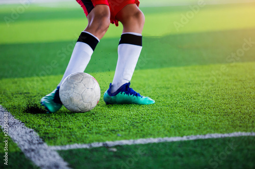 Fototapeta Naklejka Na Ścianę i Meble -  The kid Asian soccer player shoot ball.