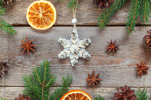 Christmas New Year composition with tree toy fir branch pine cones orange slices on old shabby rustic wooden background Xmas holiday december decoration. Flat lay top view Time for celebration concept