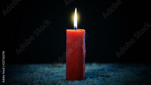 Принти на полотні Red candle burning on dark background