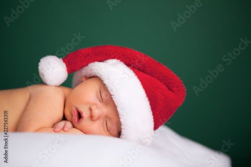 Christmas Newborn Baby Wearing Santa Hat and Sleeping